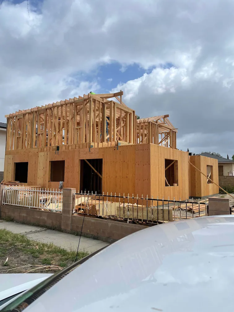 Framing in progress for a newly constructed two-story house.